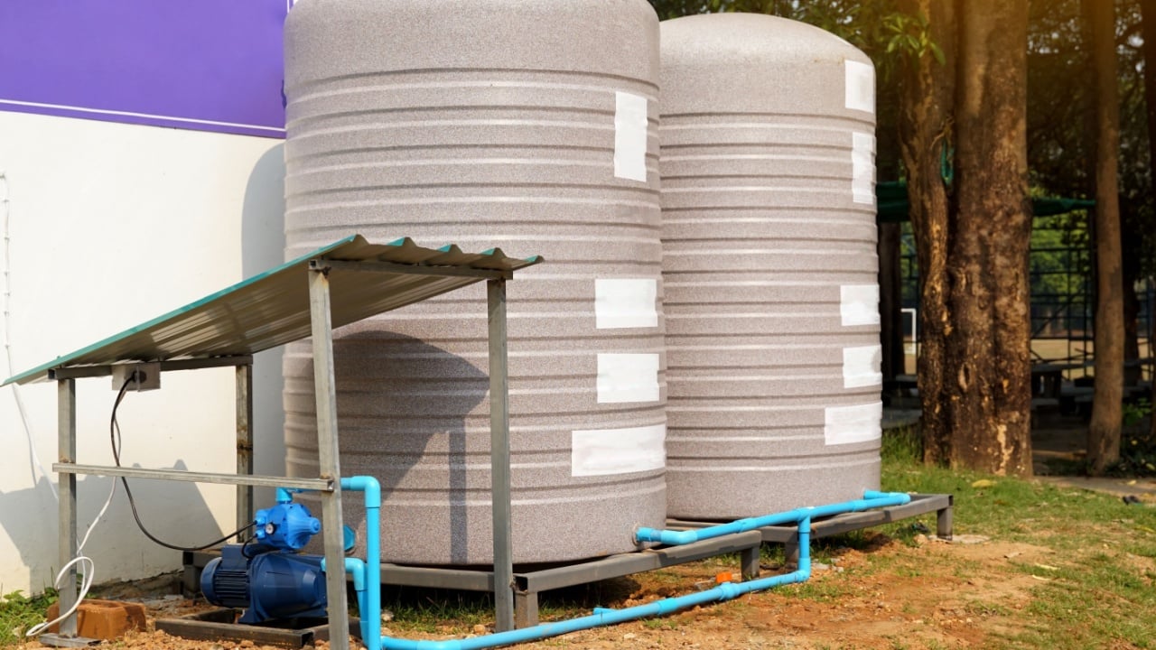 water tank and water pump installed outside the building. For use as a reserve of water for use in homes and offices. Made of special grade material, extra thick, UV protection and not moss.