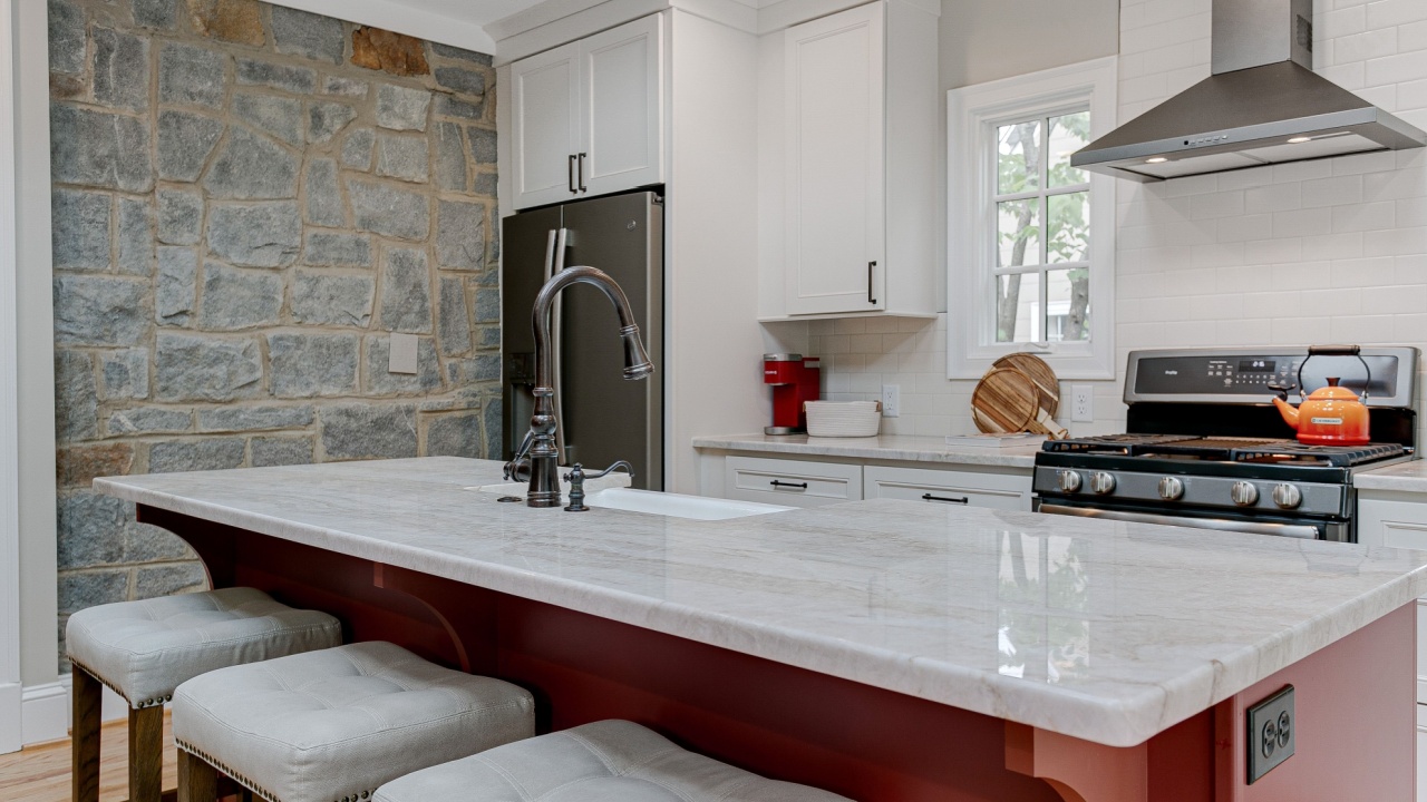 Luxury Spring Modern Kitchen Interior with White Marble Countertops and Red Island and Oval Window