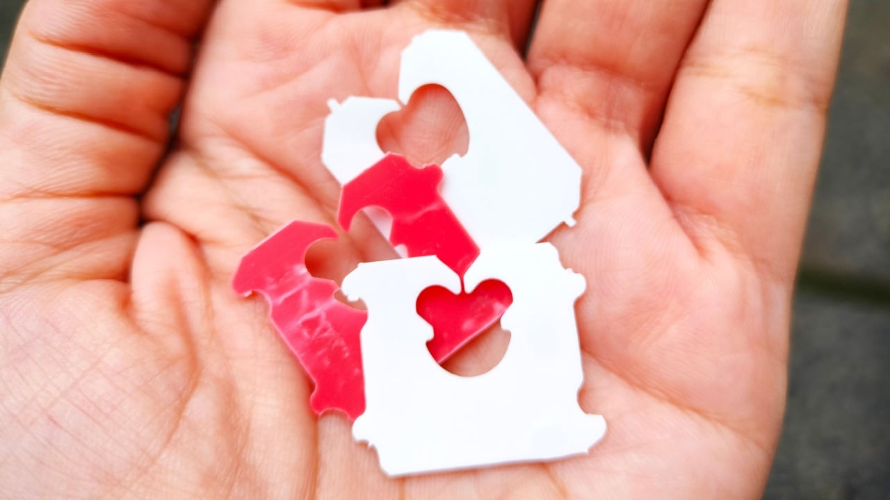 Hand holding plastic bread clips or bread tags. The color of plastic tags on bread bag use to tell you which day of the week bread was baked on.
