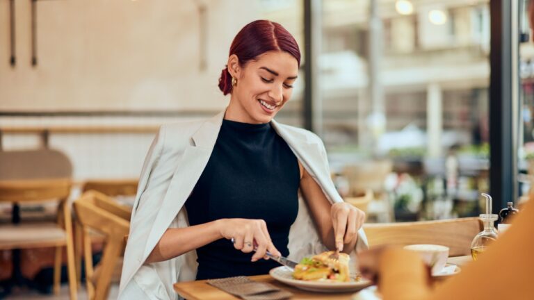red-haired woman, eating breakfast at the restaurant.