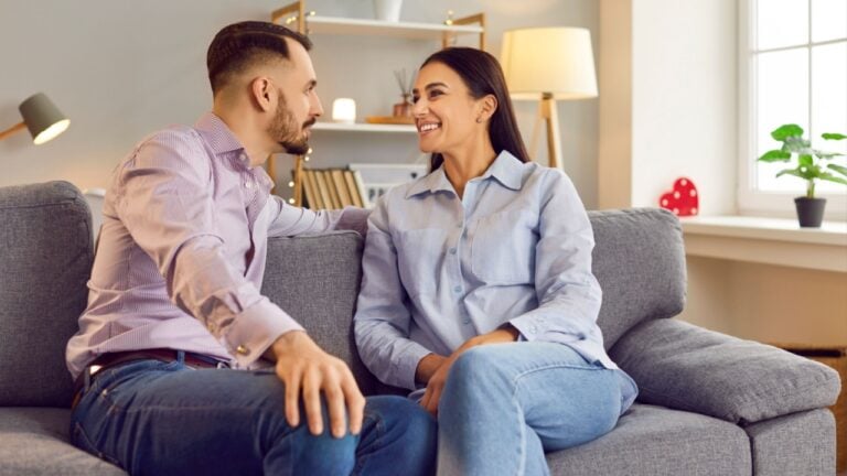 Happy smiling people in love expression sitting close, showing romantic moment feelings. Valentine day emotion, loving male, female couple healthy relationship, family pair respect between partners