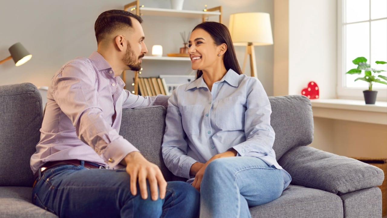 Happy smiling people in love expression sitting close, showing romantic moment feelings. Valentine day emotion, loving male, female couple healthy relationship, family pair respect between partners