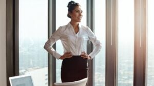 Business, thinking and window with woman, career ambition and decision with corporate success. Person, view and accountant with positive mindset, executive office or company development with solution