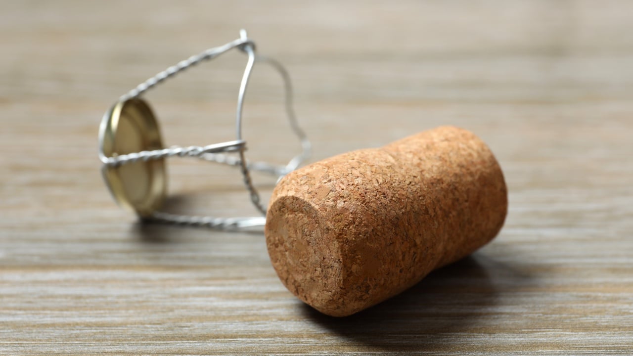 Champagne cork on wooden background