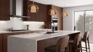 This stylish, contemporary kitchen features sleek cabinetry, a spacious island for cooking, and inviting warm lighting.