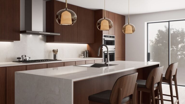 This stylish, contemporary kitchen features sleek cabinetry, a spacious island for cooking, and inviting warm lighting.