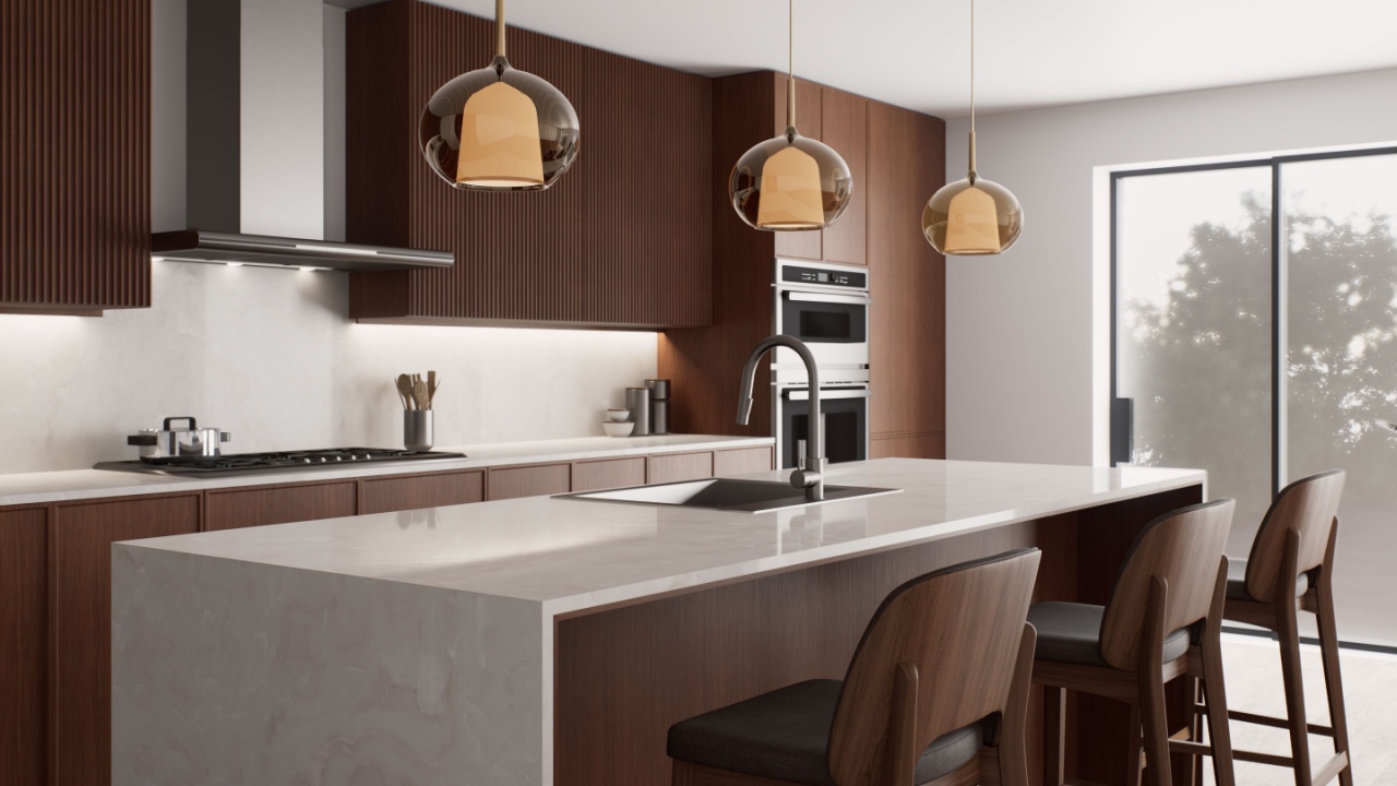 This stylish, contemporary kitchen features sleek cabinetry, a spacious island for cooking, and inviting warm lighting.