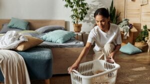 Bright and airy space where a young woman organizes laundry and enjoys a clean atmosphere.