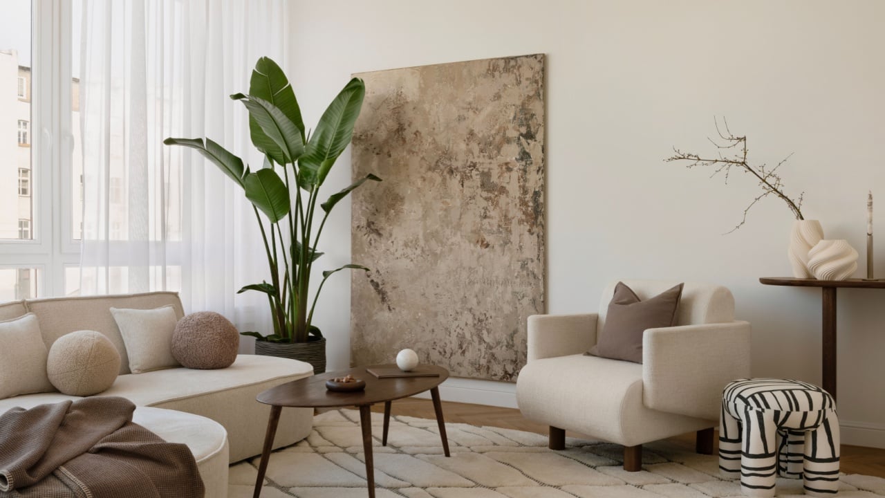 Cozy modern interior with layered textures, sculptural vases, and soft neutral tones.