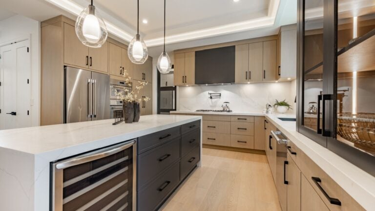 kitchen interior with dark cabinets large kitchen island with white marble and bar stools black leather hardwood floor pendant lighting window covering spacious modern new construction family home