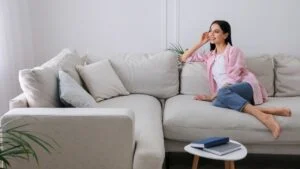 Woman resting on sofa in living room