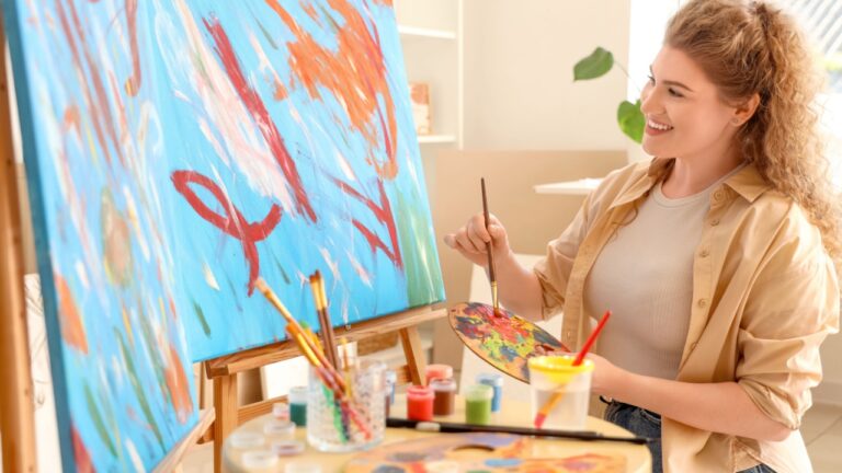 Female artist with brush and palette painting