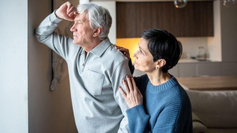 Pensive sad elderly man with distant gaze avoiding conversation with wife trying to connect. Senior trouble, marital tension, emotional distance, health struggle, silent conflict, old couple late life