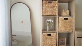 Cozy room with decorative shelves, mirror, and flowers