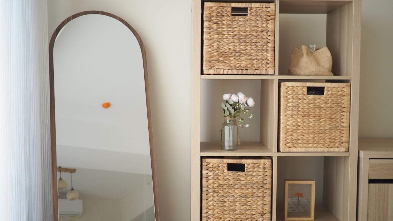 Cozy room with decorative shelves, mirror, and flowers