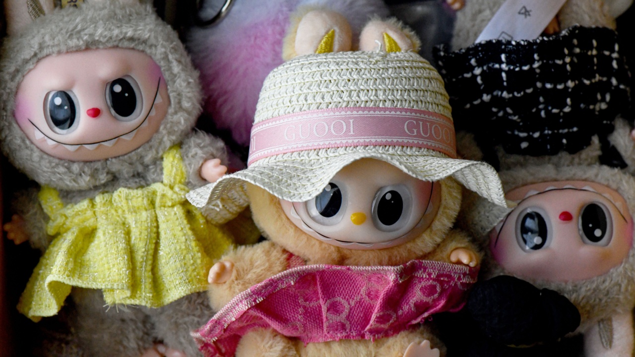 nicosia cyorus 08242025 Labubu doll is wearing a custom-made hat with luxury brands name and pink outfit. Photo represents modern trend of customizing collectible designer art toys with unique clothes