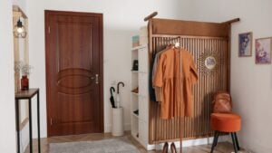 Modern hallway interior with stylish furniture and clothes rack