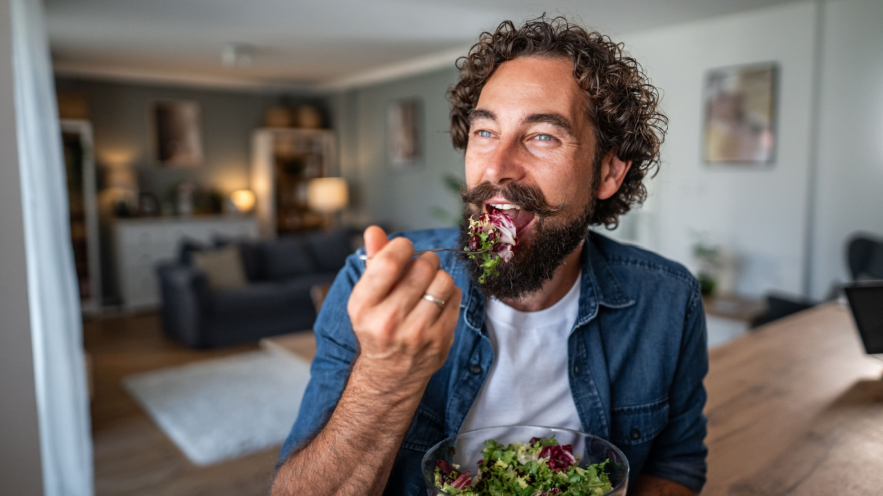 man eating a salad