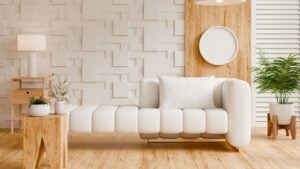Contemporary living room interior design featuring white modular sofa, textured geometric wall.