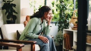 Brain fog, headache and stress with woman in living room of home for burnout, discomfort or pain. Migraine, dizzy and temple massage with mature person in apartment for recovery or symptom relief