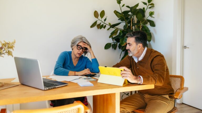 Senior couple stressed while evaluating financial plan and budgeting at home