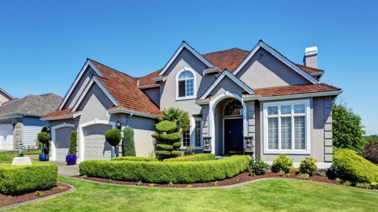 Luxury residential house with perfectly kept front garden and blue sky background. Northwest, USA