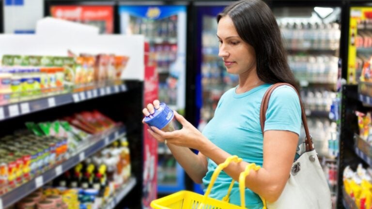 Beautiful woman buys canned