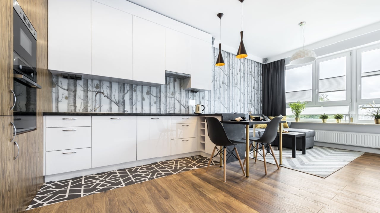 Modern small room with kitchen area and wooden floor
