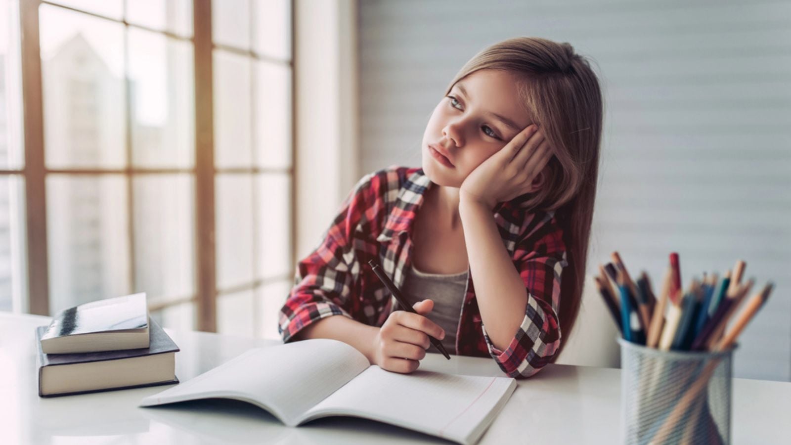 child learning at school writing thinking pencils