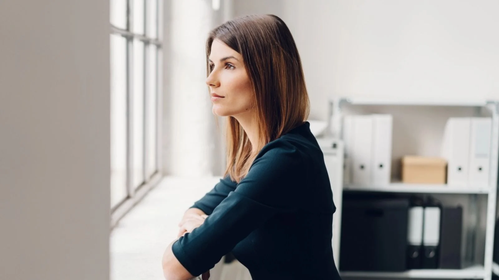 thinking Woman staring out of a window