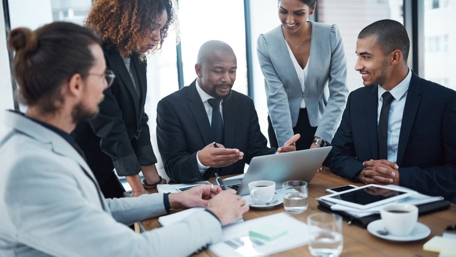 Discussion, planning and business people with laptop in office for financial review, strategy and collaboration.