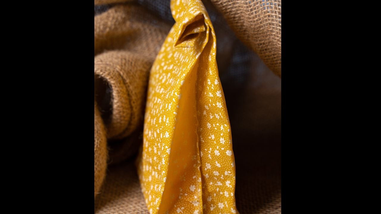 Reusable Beeswax Food Wraps. Organic fabric covers for food storage. Beeswax in studio. Beeswax zero waste product. Yellow bee wax bag.