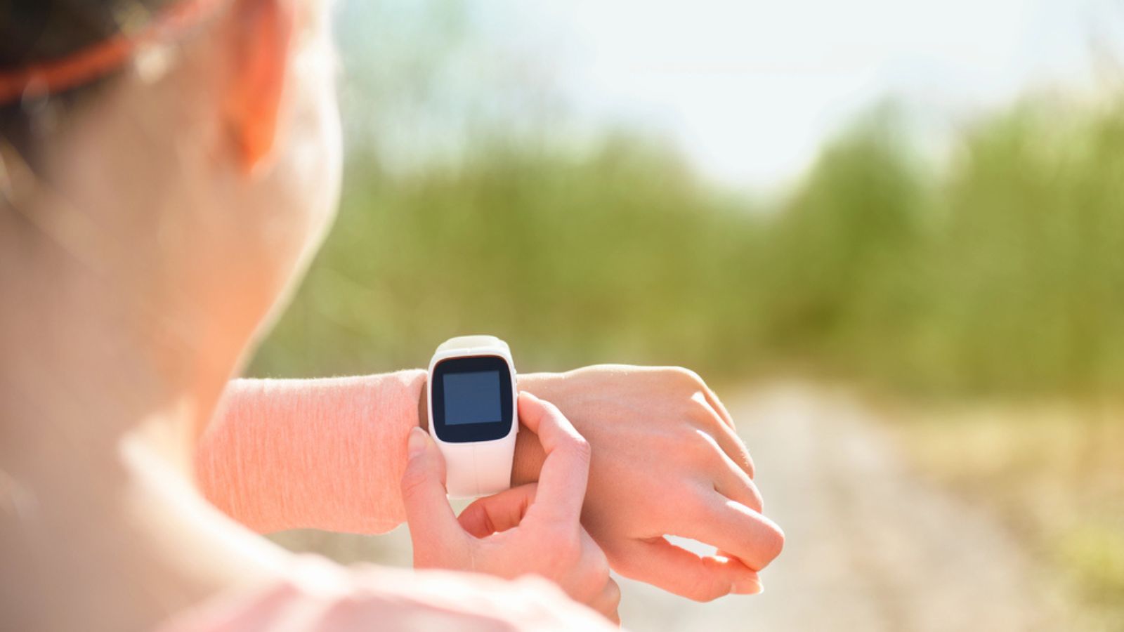 Runner looking at sports smartwatch
