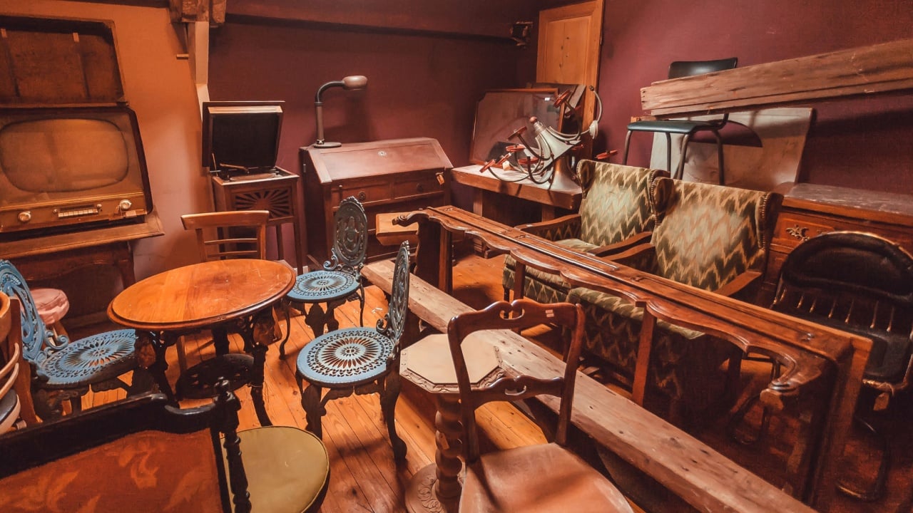 BRUSSELS, BELGIUM - APR 2: Old cabinet in antique store with many vintage utensil, decor, wooden furniture, retro armchairs on April 2, 2018. More than 1,200,000 people lives in Brussels