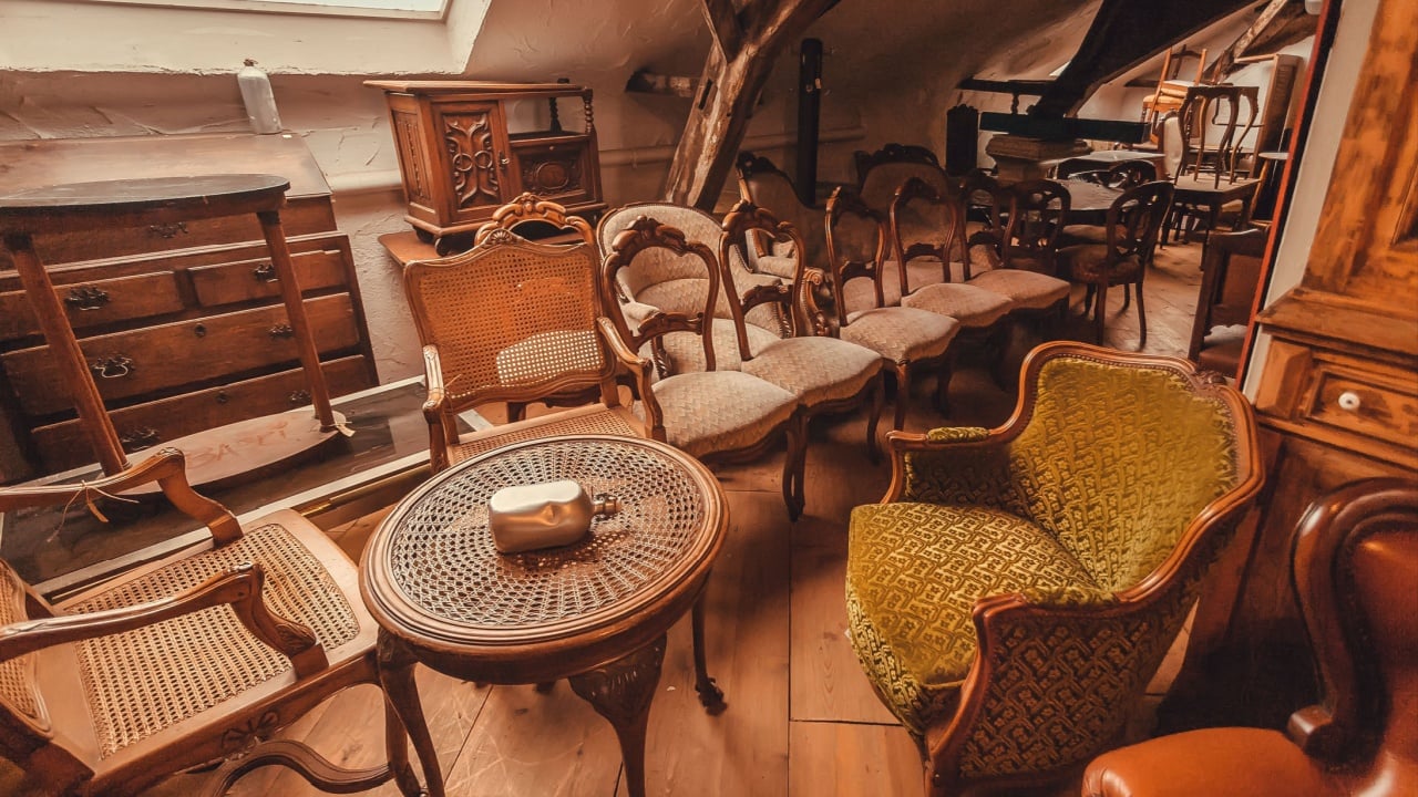 BRUSSELS, BELGIUM - APR 2: Antique metal tables, vintage armchairs, decoration, wooden furniture and retro details of old house on April 2, 2018. More than 1,200,000 people lives in Brussels