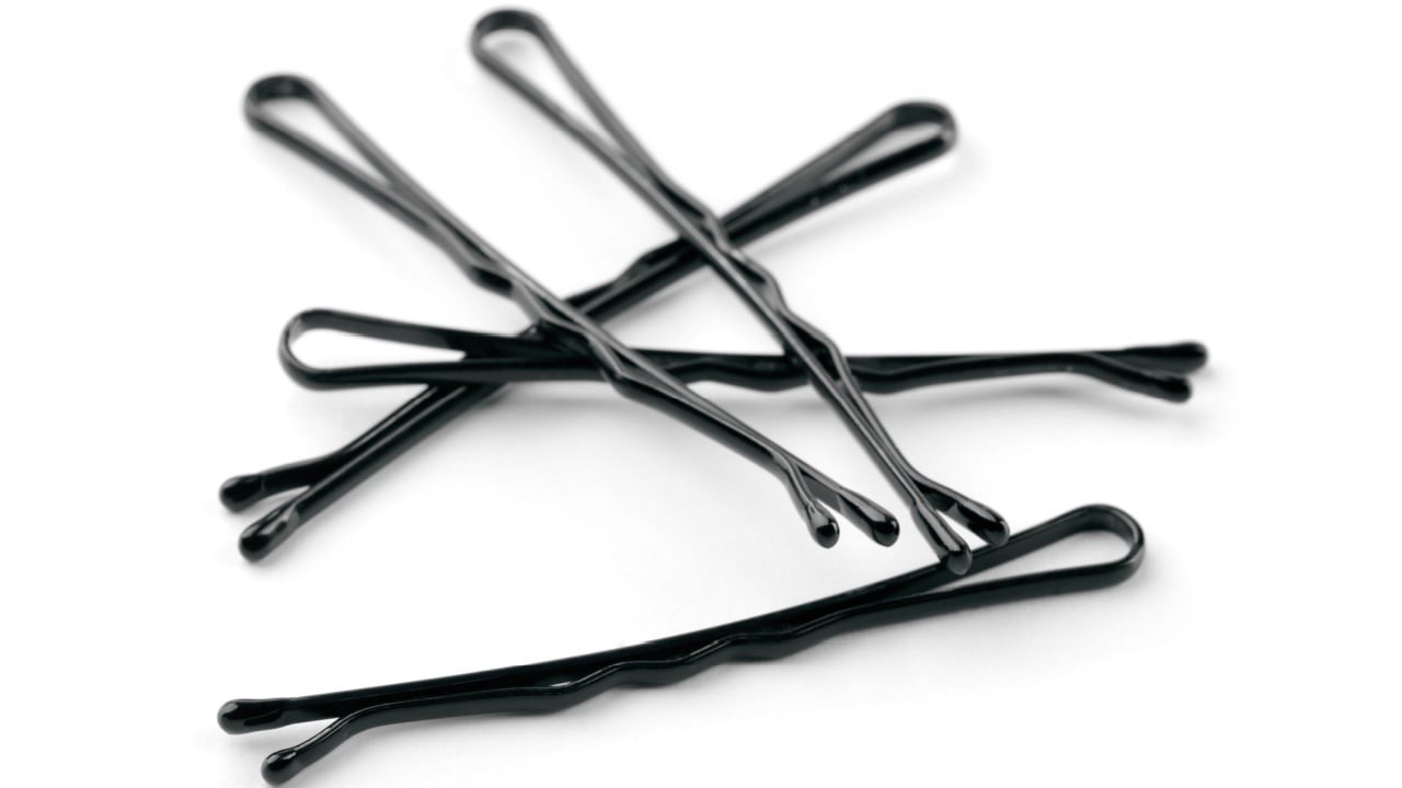 Group of black metal hairpins isolated on white