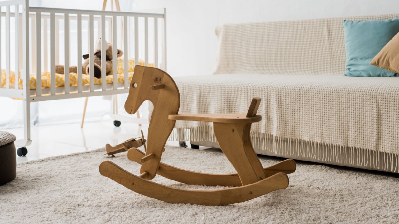 modern interior design of nursery room with crib and rocking horse chair
