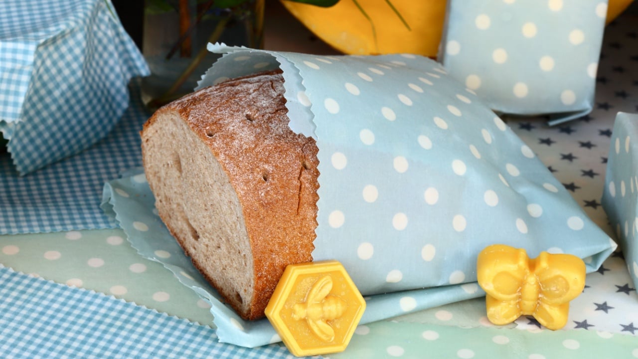 bread is packed in a waxed- cloth on table