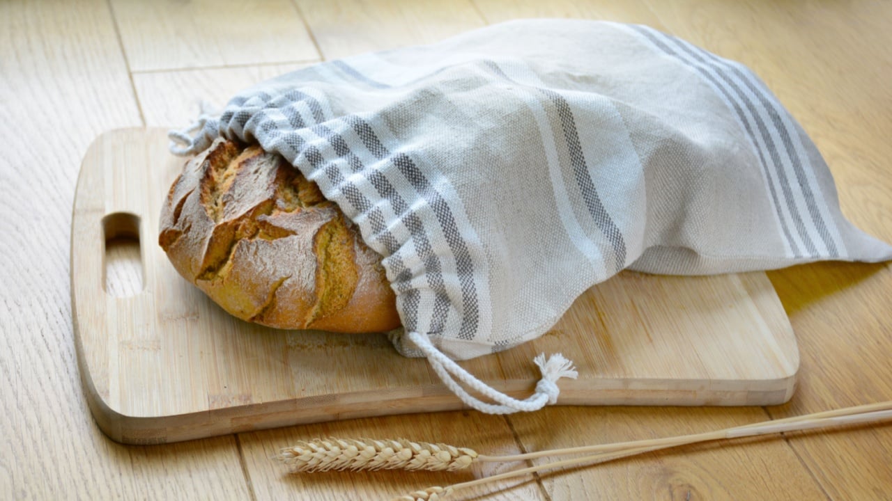 Bread loaf in reusable zero waste linen bread bag, close-up view