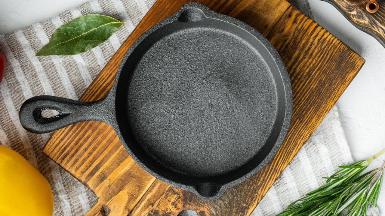 Empty frying cast iron pan background, kitchenware cooking concept set, on white stone surface, top view flat lay.