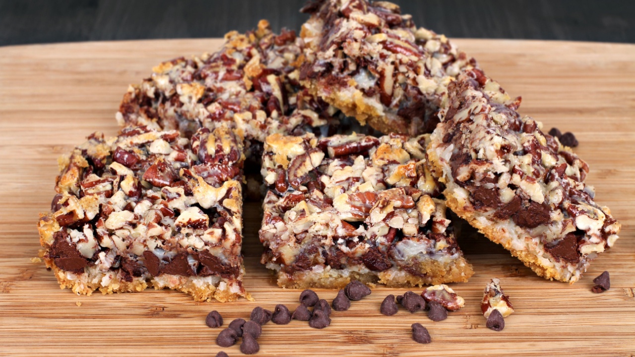 Fresh baked cookie bars made with chocolate chips and chopped pecans. Selective focus on front row.