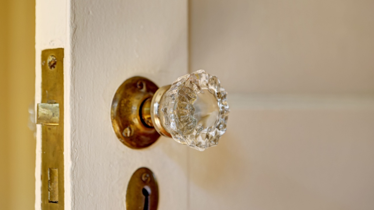 Close up view of clear door handle and keyhole in old house
