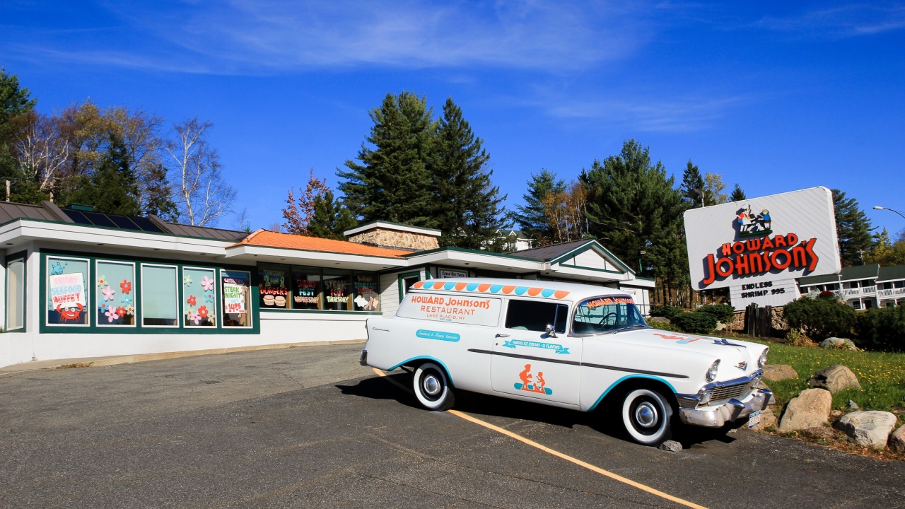 Lake Placid, New York, USA, October 13, 2010 - Entrance to Howard Johnson with vintage delivery station wagon seen during a sunny fall day