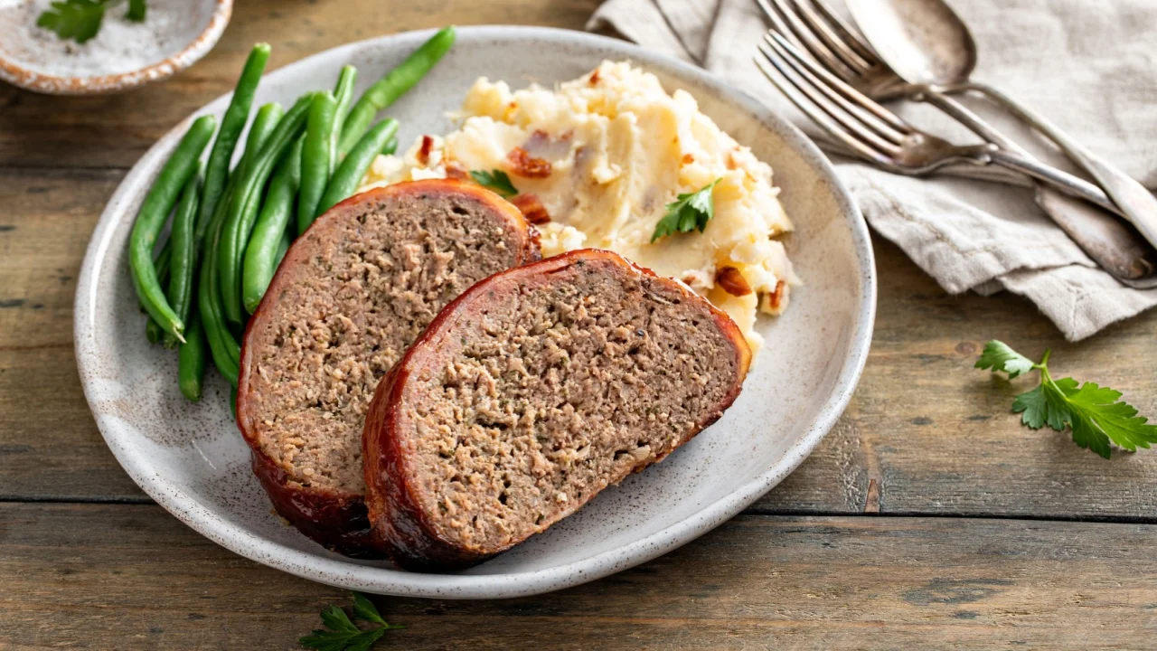 Meatloaf with mashed potatoes and green beans, traditional dinner meal, serving on a plate