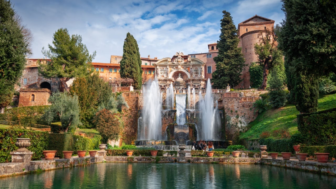 TIVOLI, ITALY - FEBRUARY 5, 2022: Visitors enjoy waterworks at Villa D'Este. The 16th century villa is now a museum and an UNESCO World Heritage site.
