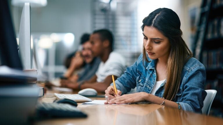 Successful futures dont just happen, theyre earned. Shot of a young woman studying in a college library.