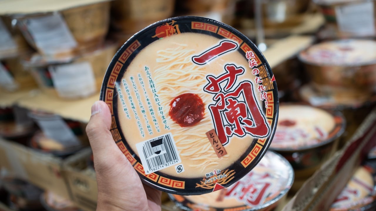 KUALA LUMPUR, MALAYSIA - APR 23, 2022: Hand holding Japan brand Ichiran Ramen instant noodle with isolated blur background.