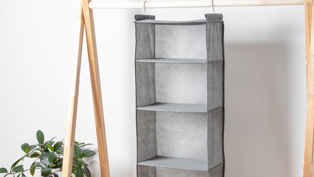 Grey hanging organizer for clothes. Storage system for wardrobe