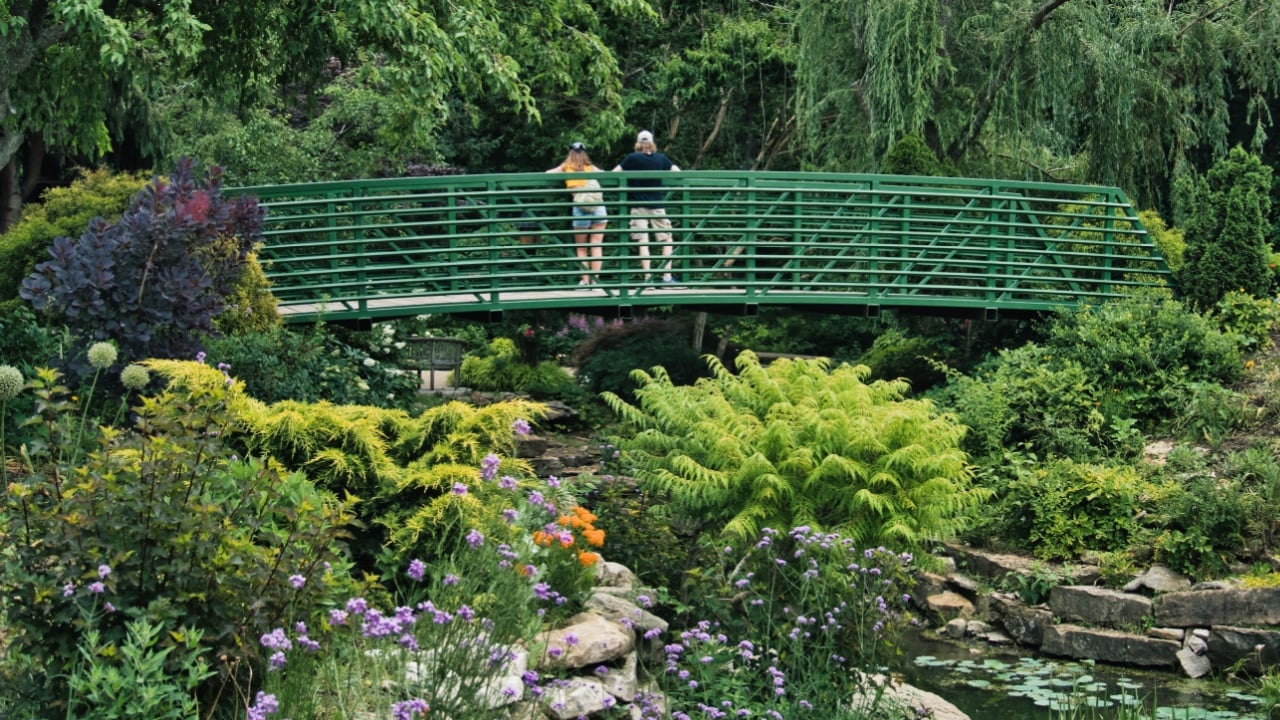 OVERLAND PARK, UNITED STATES - Jun 12, 2022: A couple standing on the bridge of Claude Monet garden in Giverny, France
