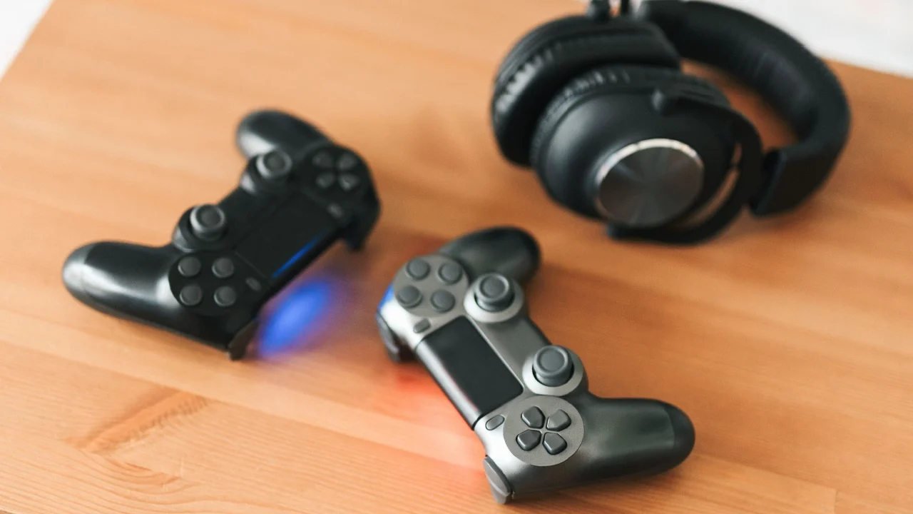 Video gaming consoles. Top view a gaming gear on the table background. Joystick or gamepad on a table.